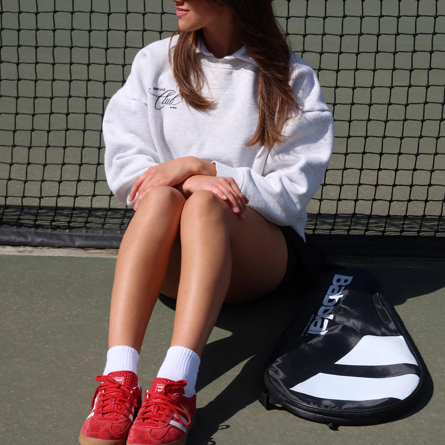 anfisa skin model wearing grey style crewneck sweater at a tennis court