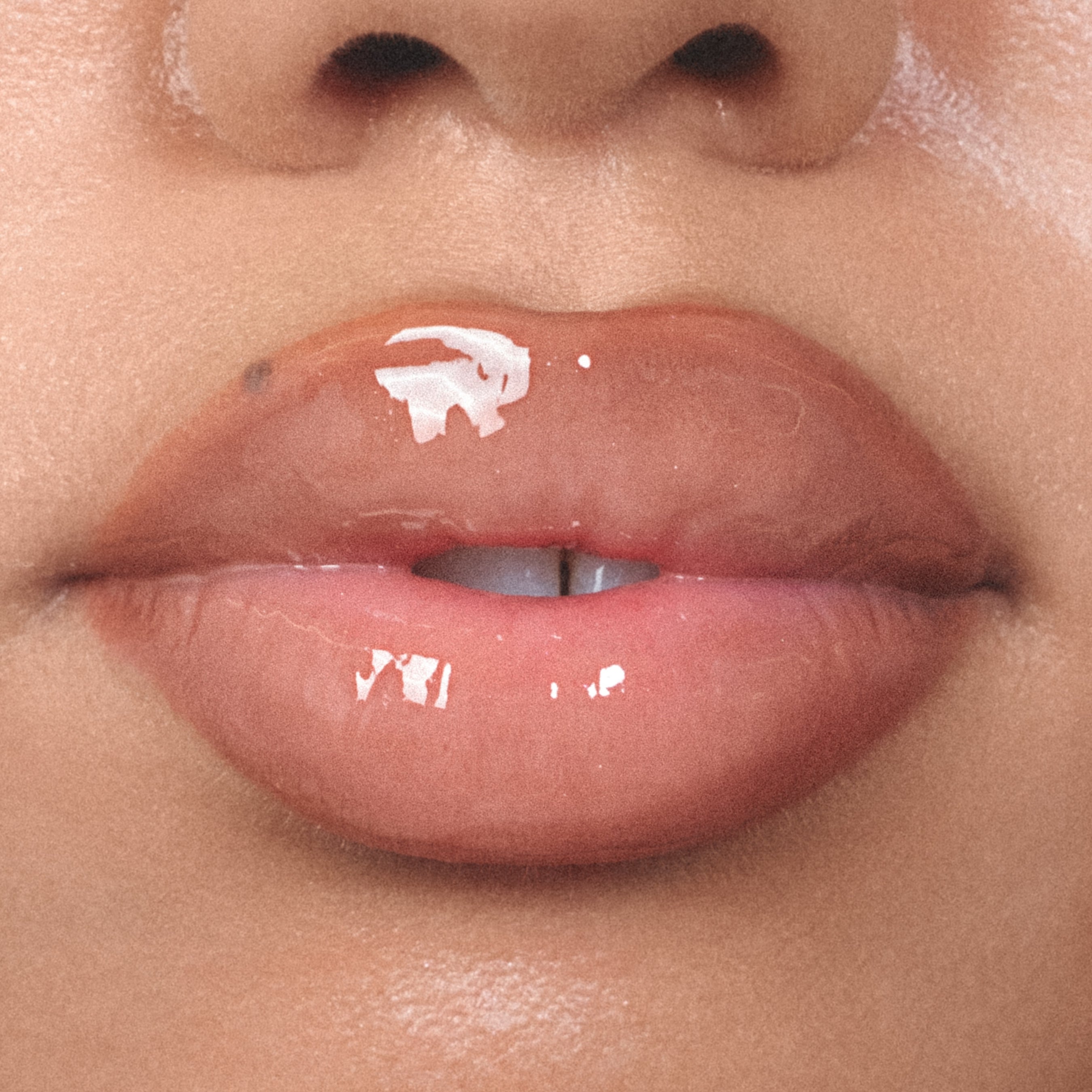 Close-up of a person's lips with an gloss lip product on